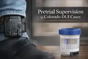 SCARM ankle monitor and drug testing cup used in DUI pretrial supervision in Colorado